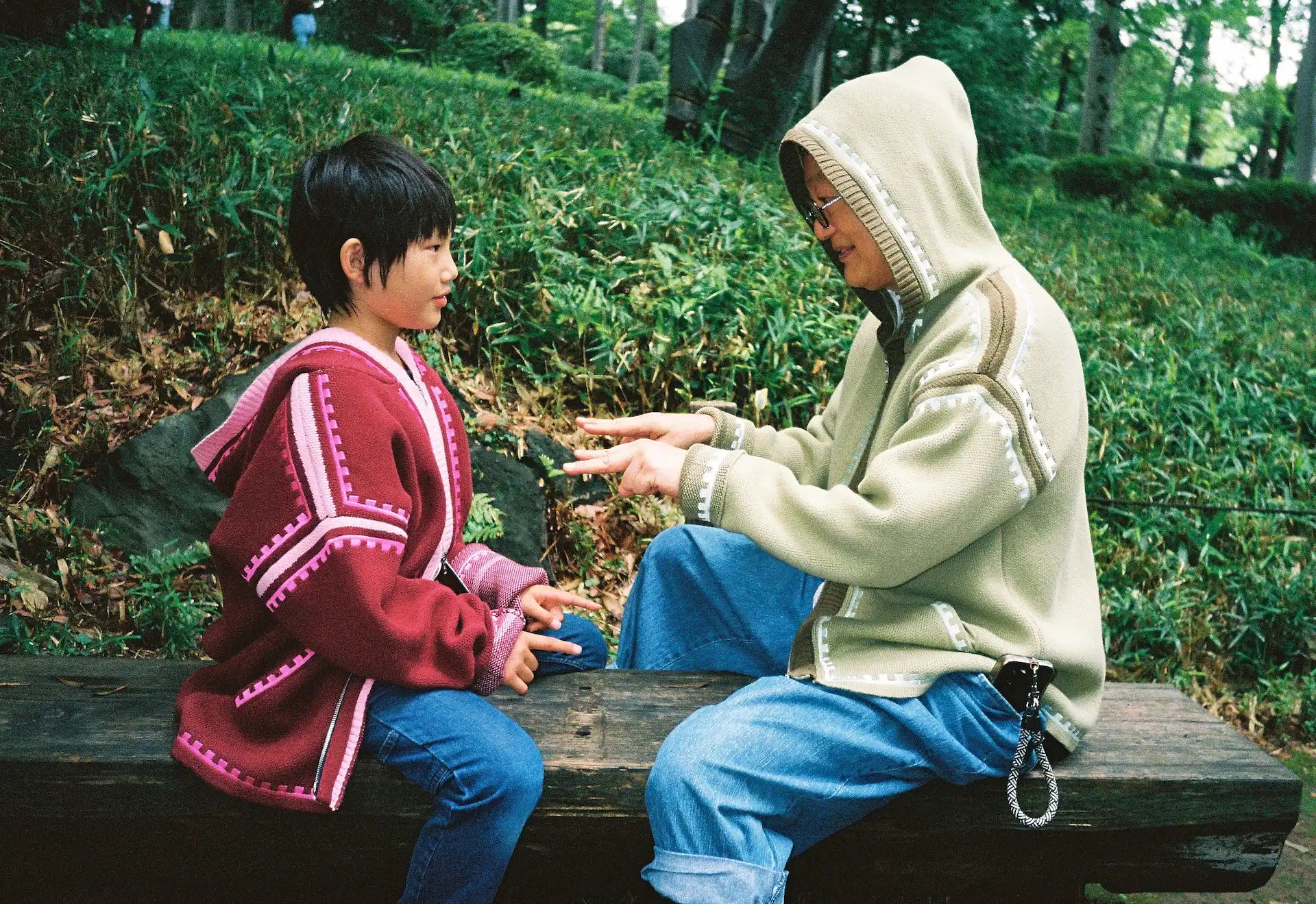 Masahiro and Kantaro wearing R'MILI Berbere Knitwear Jackets in burgundy and green playing, Tokyo 